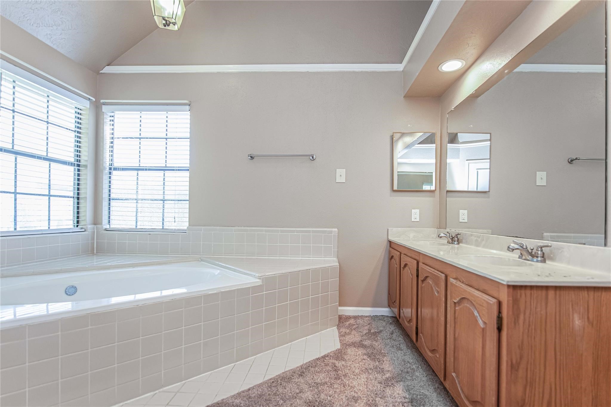10131 Wayward Wind Lane Houston, TX 77064 - Photo 12 of 16 a spacious bathroom with a tub sink and mirror
