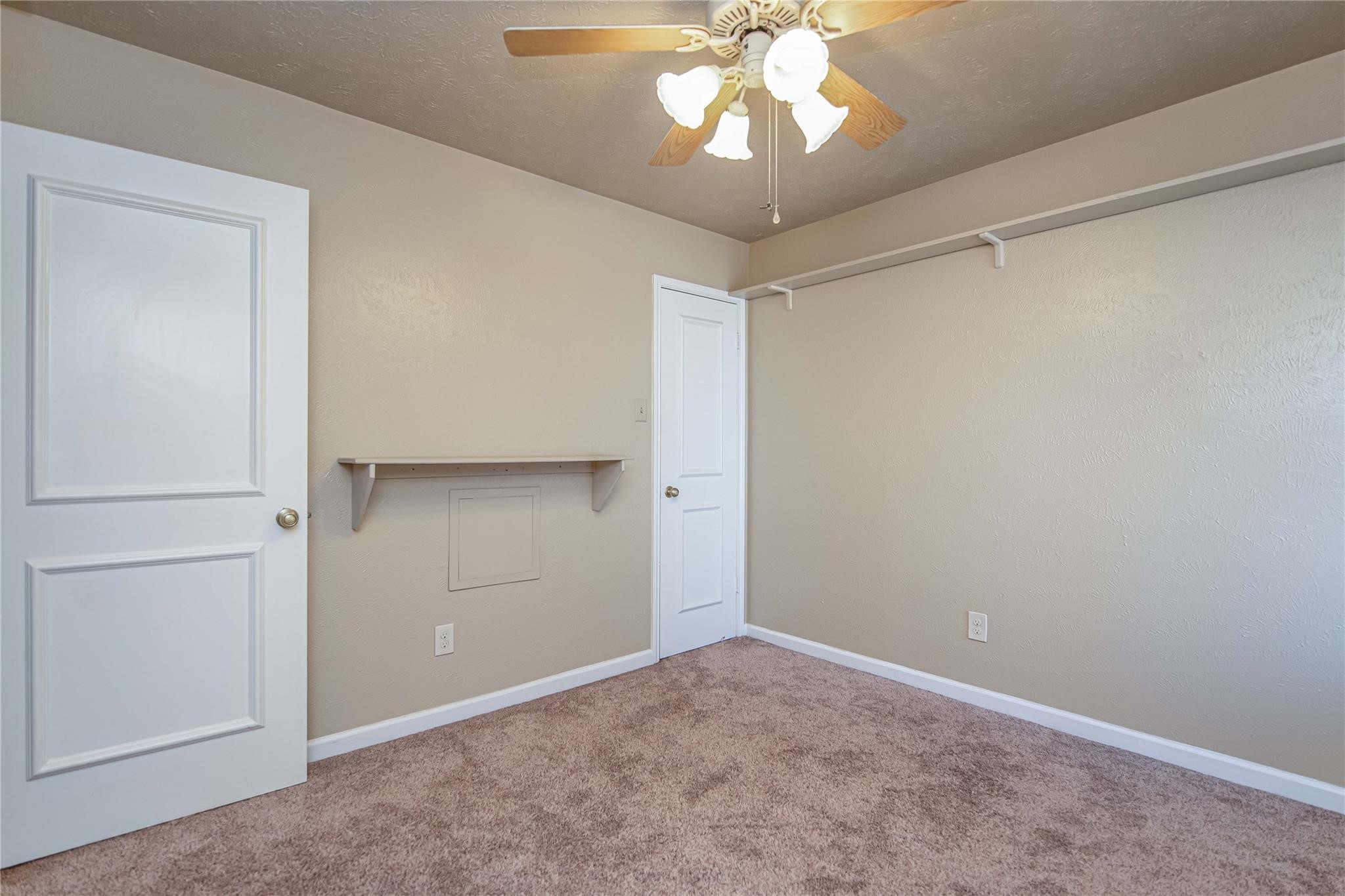 10131 Wayward Wind Lane Houston, TX 77064 - Photo 15 of 16 an empty room with a chandelier fan and closet area