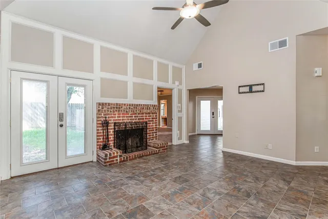 a view of an empty room with window and fire place