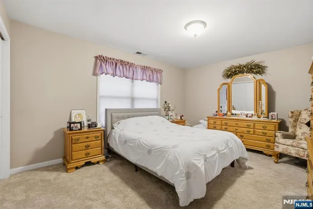 a bedroom with a bed and a night stand