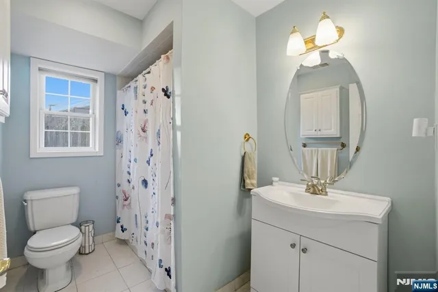 a bathroom with a toilet a sink and a mirror