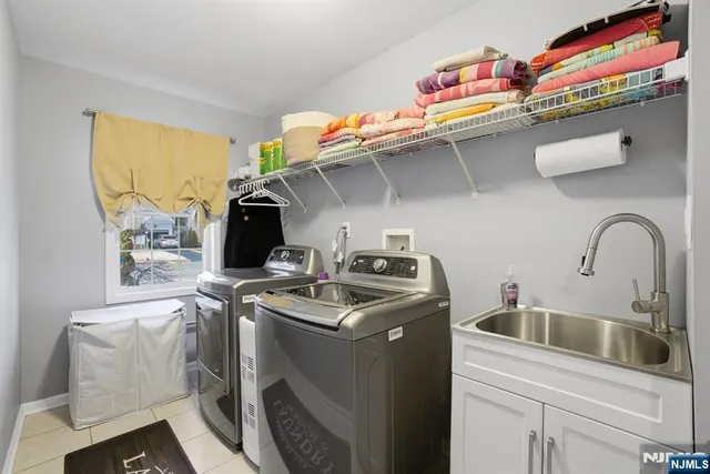 a utility room with sink dryer and washer
