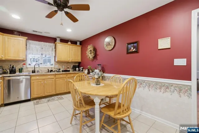a kitchen with stainless steel appliances granite countertop a sink and a refrigerator