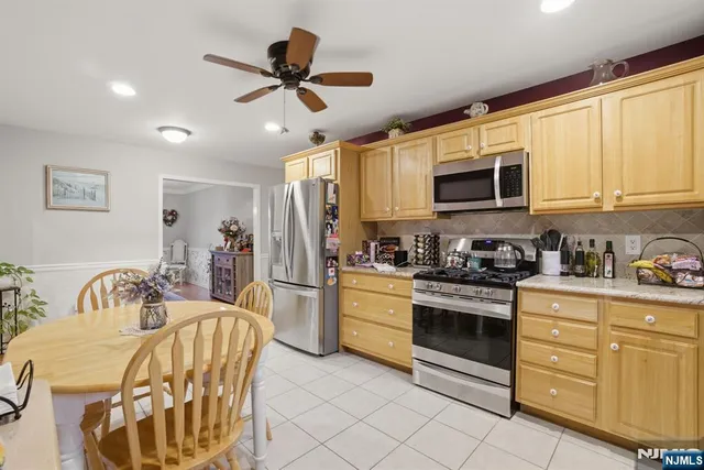a kitchen with stainless steel appliances kitchen island granite countertop a sink and cabinets