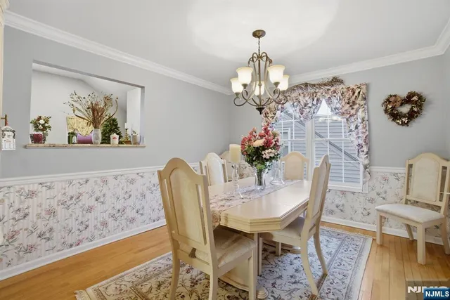 a view of a dining room with furniture and chandelier