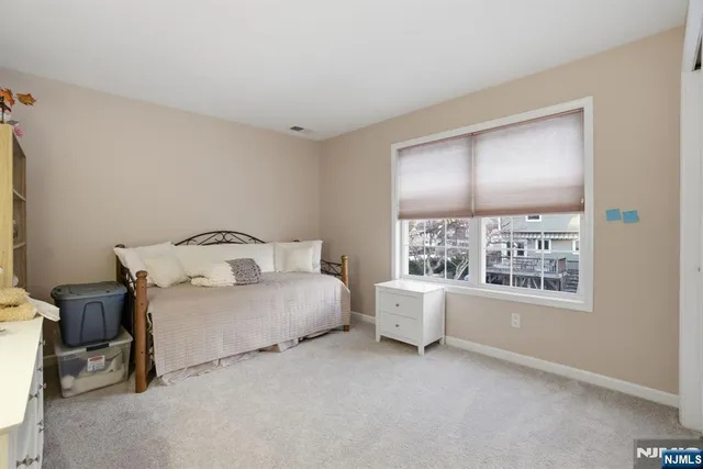 a spacious bedroom with a bed and window