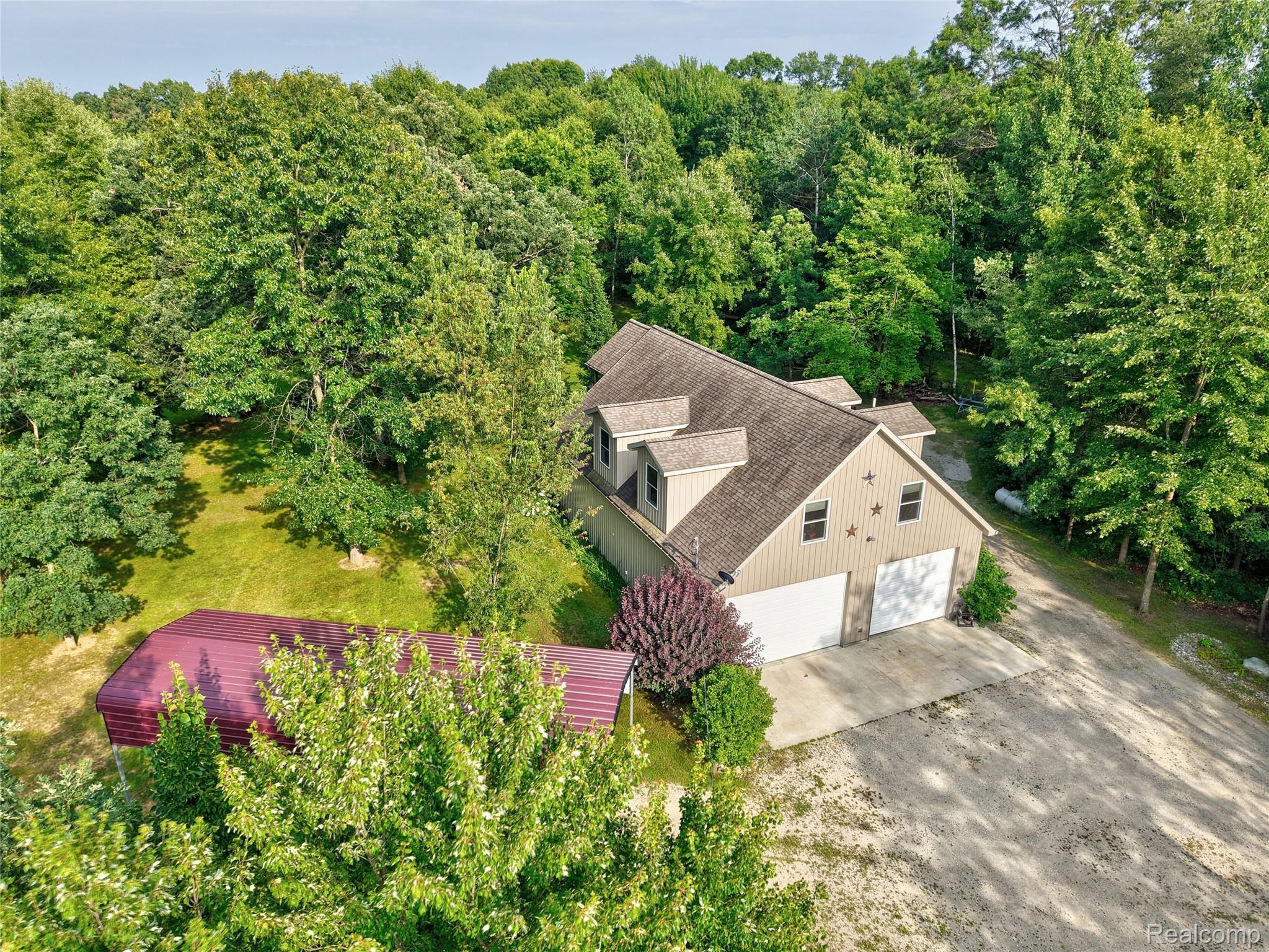15055 South Duffield Road Byron, MI 48418 - Photo 54 of 61 Light beige siding exterior with a dark shingle roof