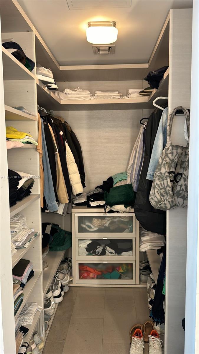 88 Southwest 7th Street, Unit 810 Miami, FL 33130 - Photo 5 of 10 a view of walk in closet with clothes and shoes