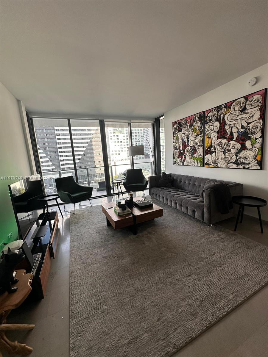 88 Southwest 7th Street, Unit 810 Miami, FL 33130 - Photo 9 of 10 a living room with furniture and a large window