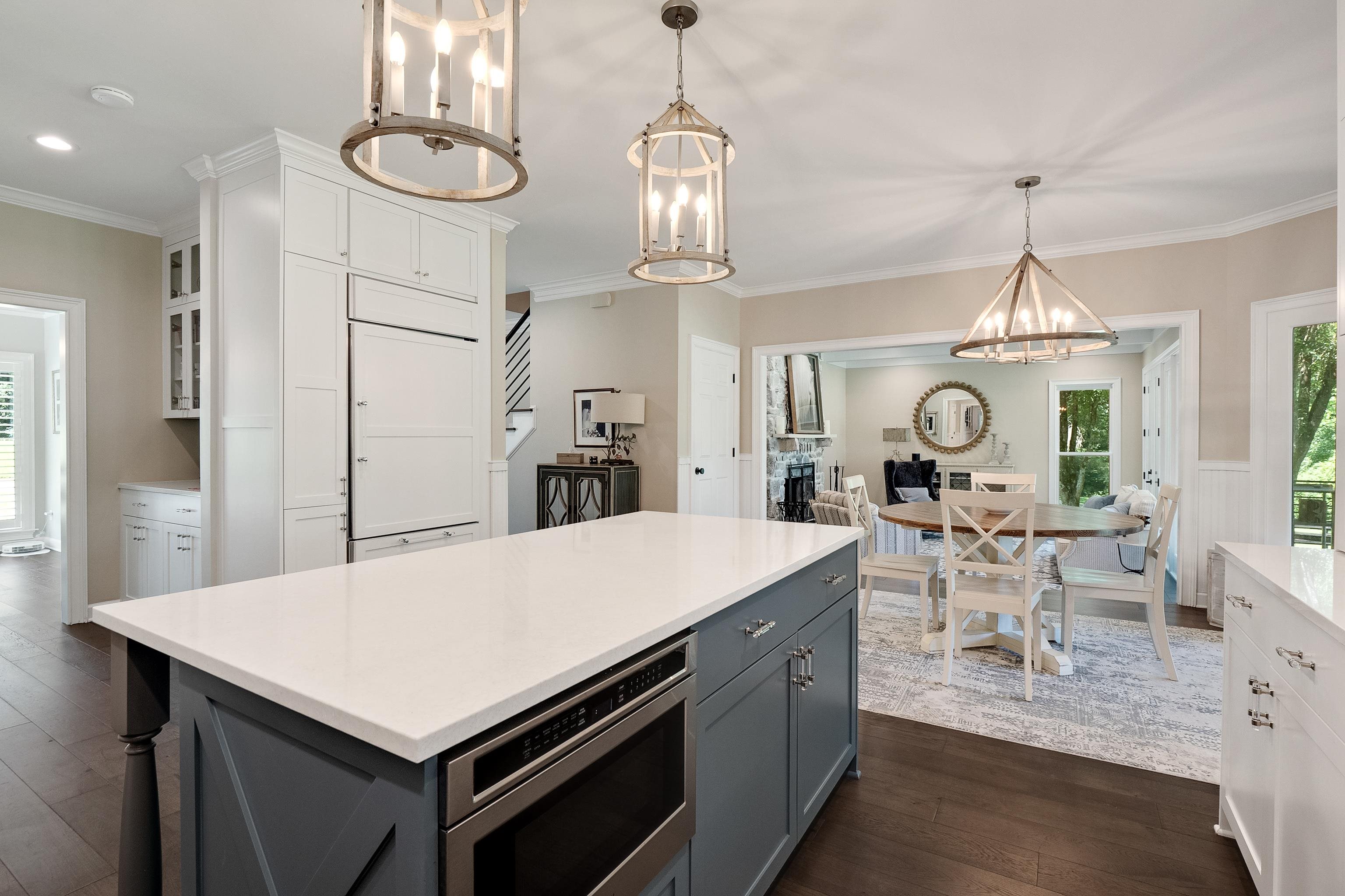 11830 Monterey Road Eads, TN 38028 - Photo 14 of 40 Kitchen featuring white cabinets, dark hardwood / wood-style floors, crown molding, and pendant lighting
