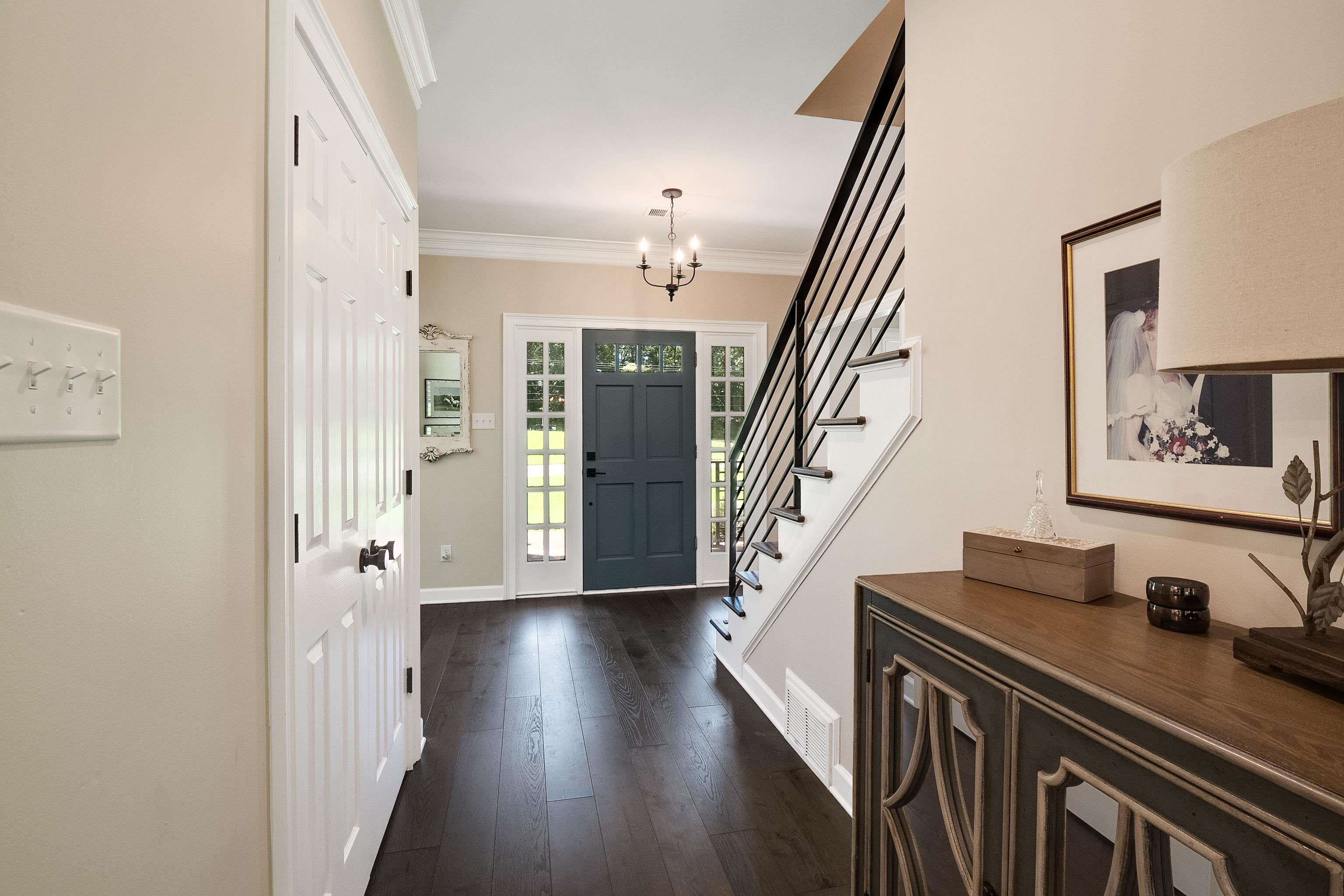 11830 Monterey Road Eads, TN 38028 - Photo 3 of 40 Entrance foyer featuring a notable chandelier, dark hardwood / wood-style flooring, and ornamental molding