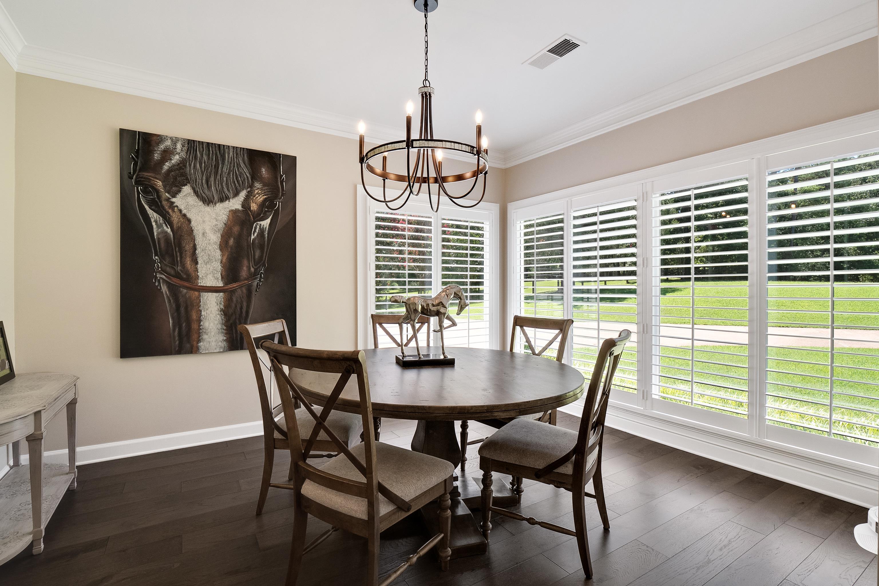 11830 Monterey Road Eads, TN 38028 - Photo 4 of 40 Dining area featuring an inviting chandelier, a healthy amount of sunlight, dark hardwood / wood-style flooring, and ornamental molding