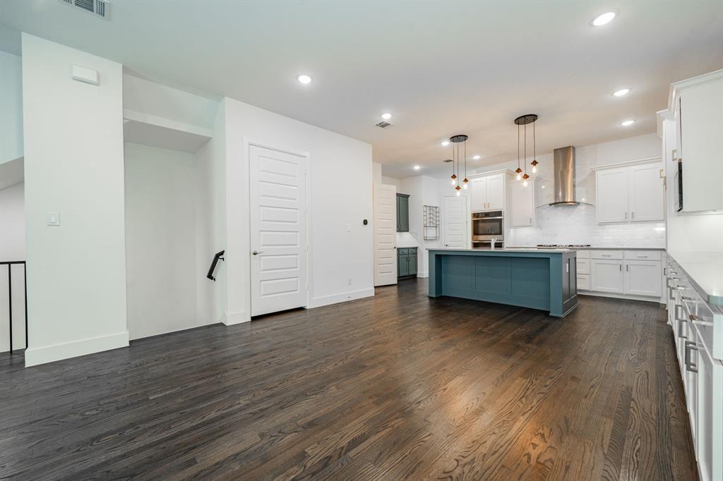 8106 Fallston Court Dallas, TX 75231 - Photo 14 of 40 a view of a kitchen with wooden floor and windows