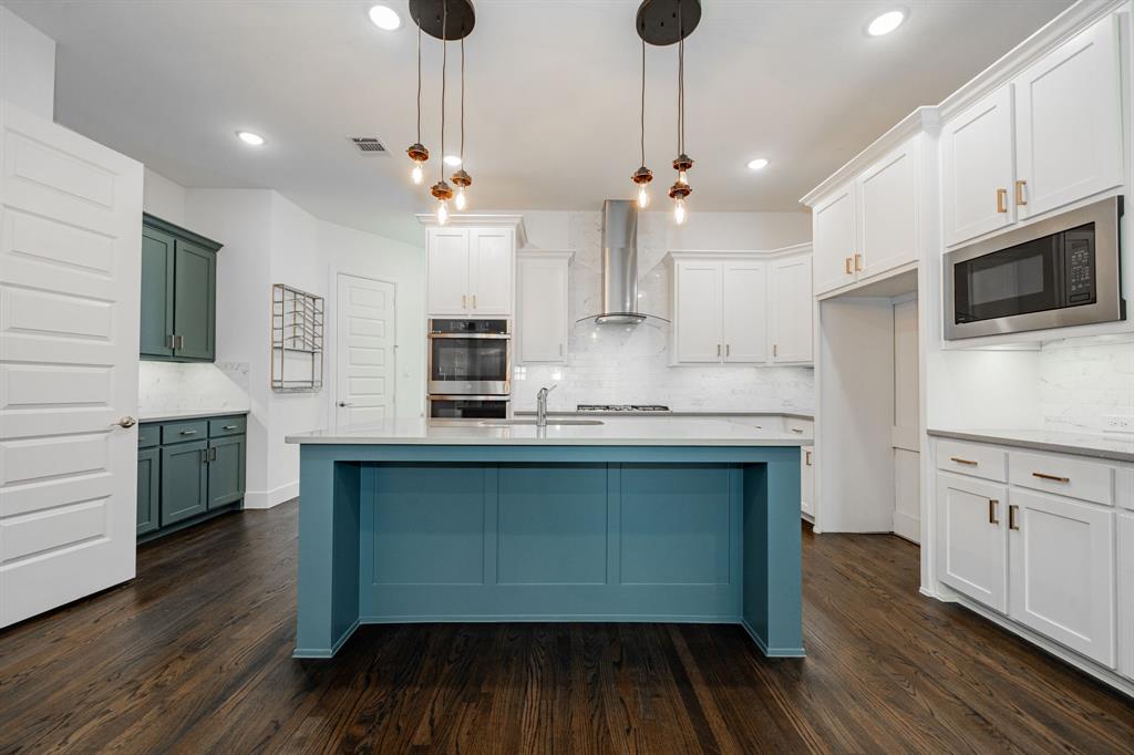 8106 Fallston Court Dallas, TX 75231 - Photo 15 of 40 a kitchen with stainless steel appliances granite countertop a sink a stove and a wooden floors