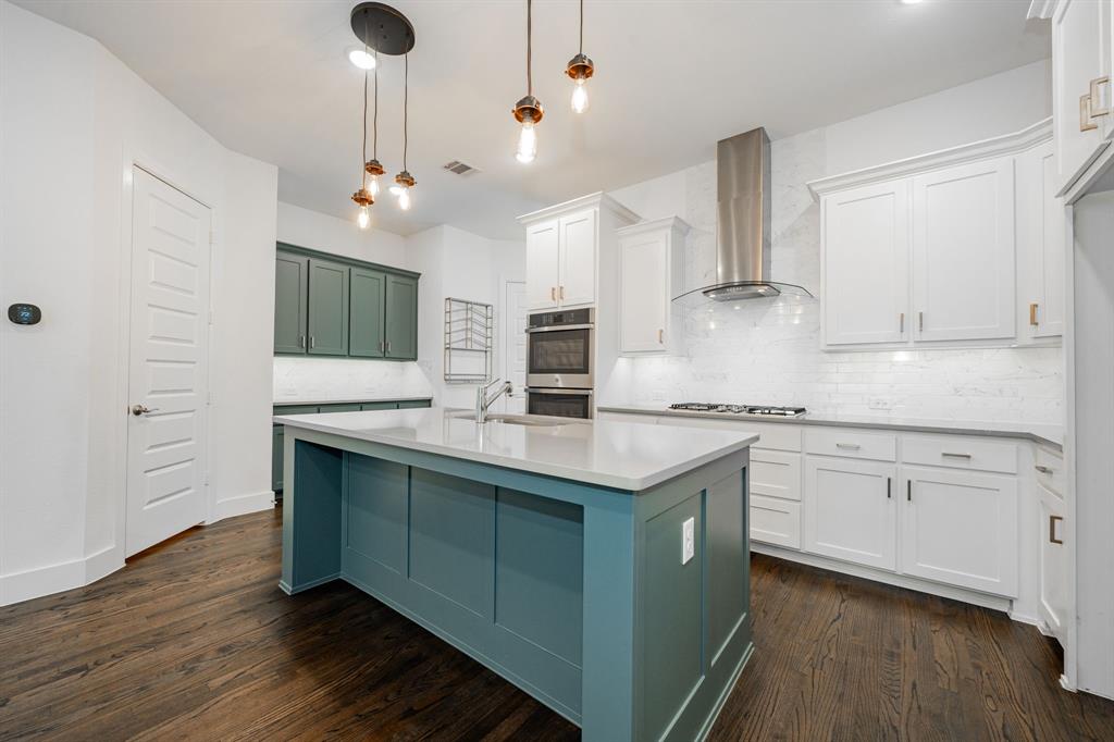 8106 Fallston Court Dallas, TX 75231 - Photo 16 of 40 a kitchen with stainless steel appliances granite countertop a sink a stove and a wooden floors