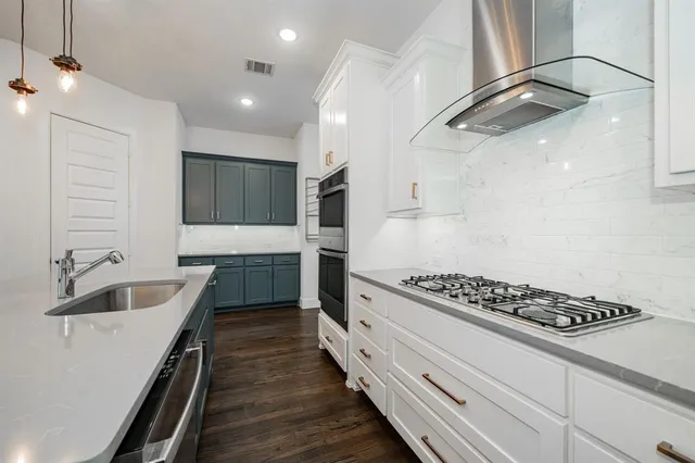 a kitchen with cabinets and a stove