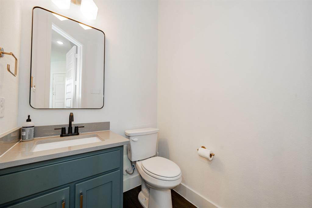 8106 Fallston Court Dallas, TX 75231 - Photo 22 of 40 a bathroom with a toilet sink and mirror