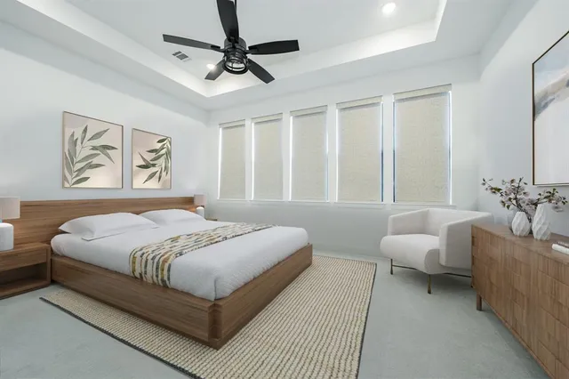 a bedroom with a large bed couch and a window