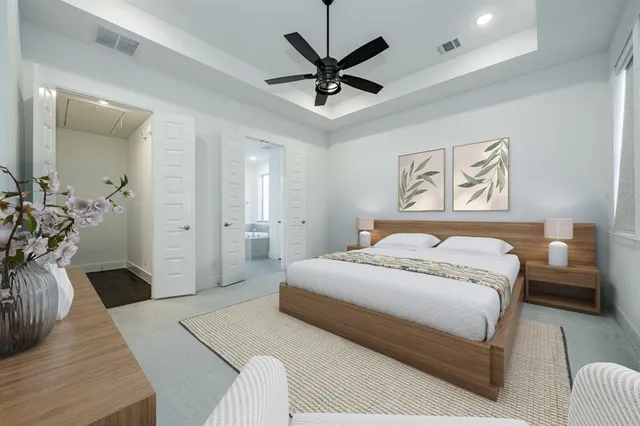 a bedroom with a bed and ceiling fan