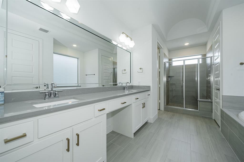 8106 Fallston Court Dallas, TX 75231 - Photo 27 of 40 a bathroom with a double vanity sink and a mirror