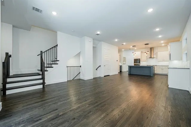 a view of kitchen with wooden floor and electronic appliances