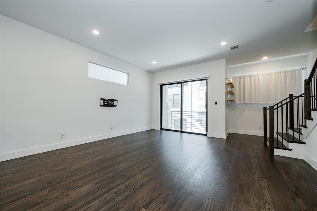 8106 Fallston Court Dallas, TX 75231 - Photo 10 of 40 a view of an empty room with wooden floor and a window