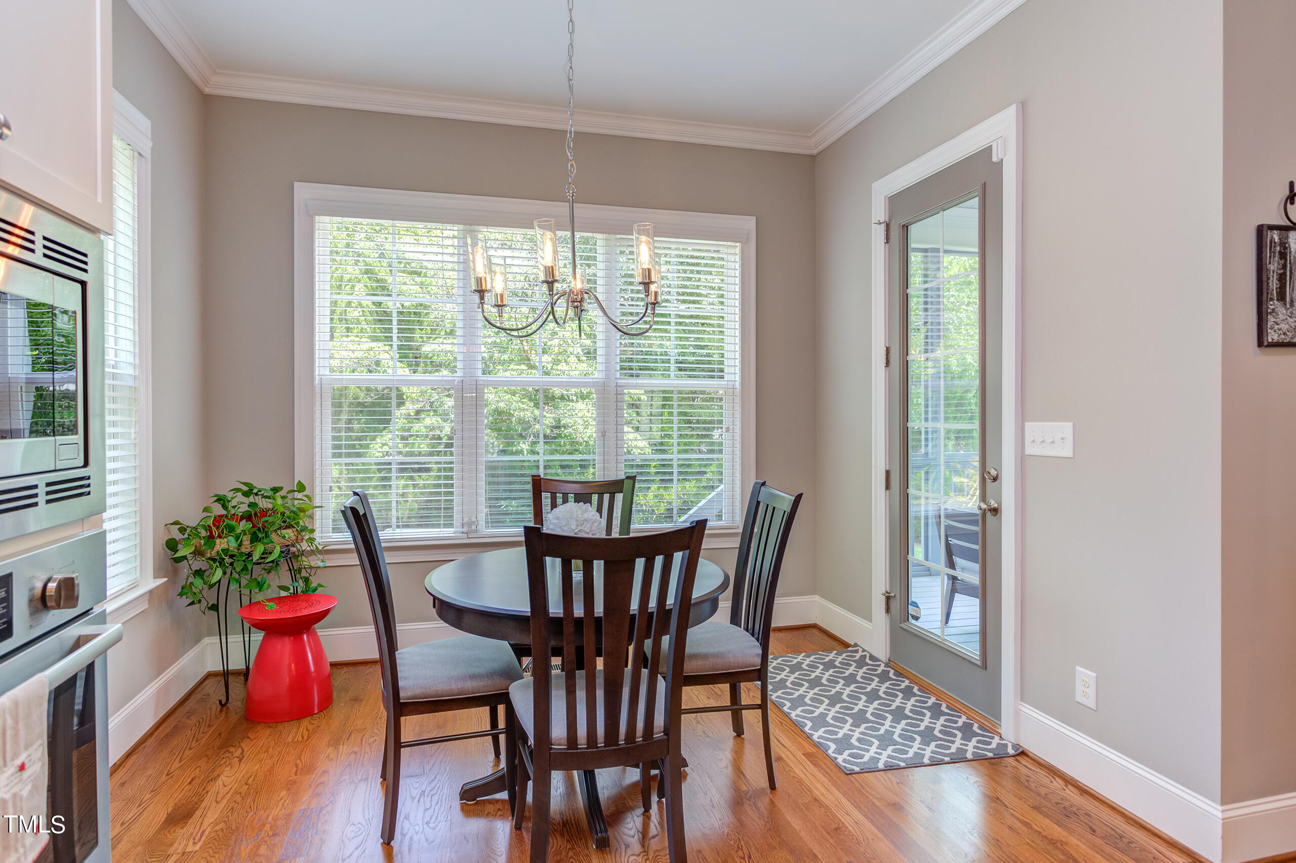 6426 Rosny Road Raleigh, NC 27613 - Photo 15 of 51 a view of a dining room with furniture window and wooden floor