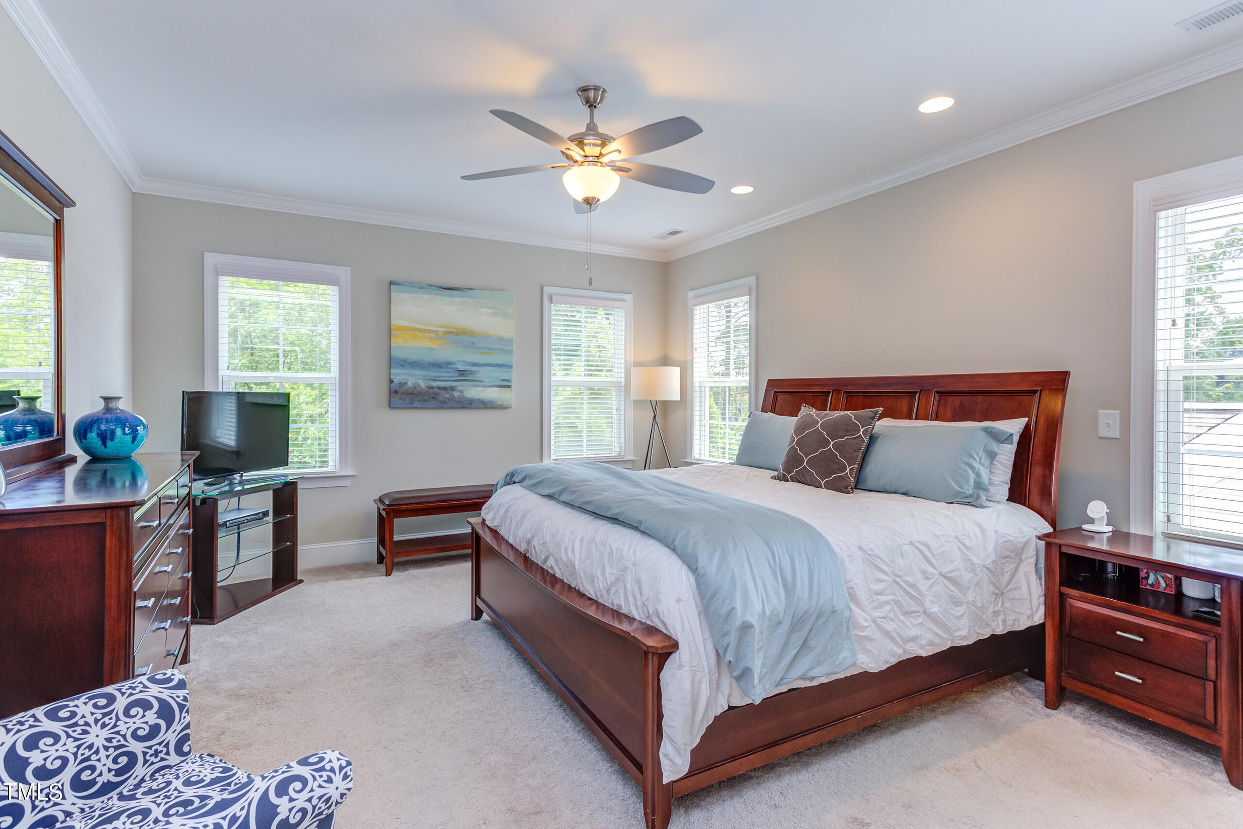 6426 Rosny Road Raleigh, NC 27613 - Photo 25 of 51 a bedroom with a bed and a chandelier