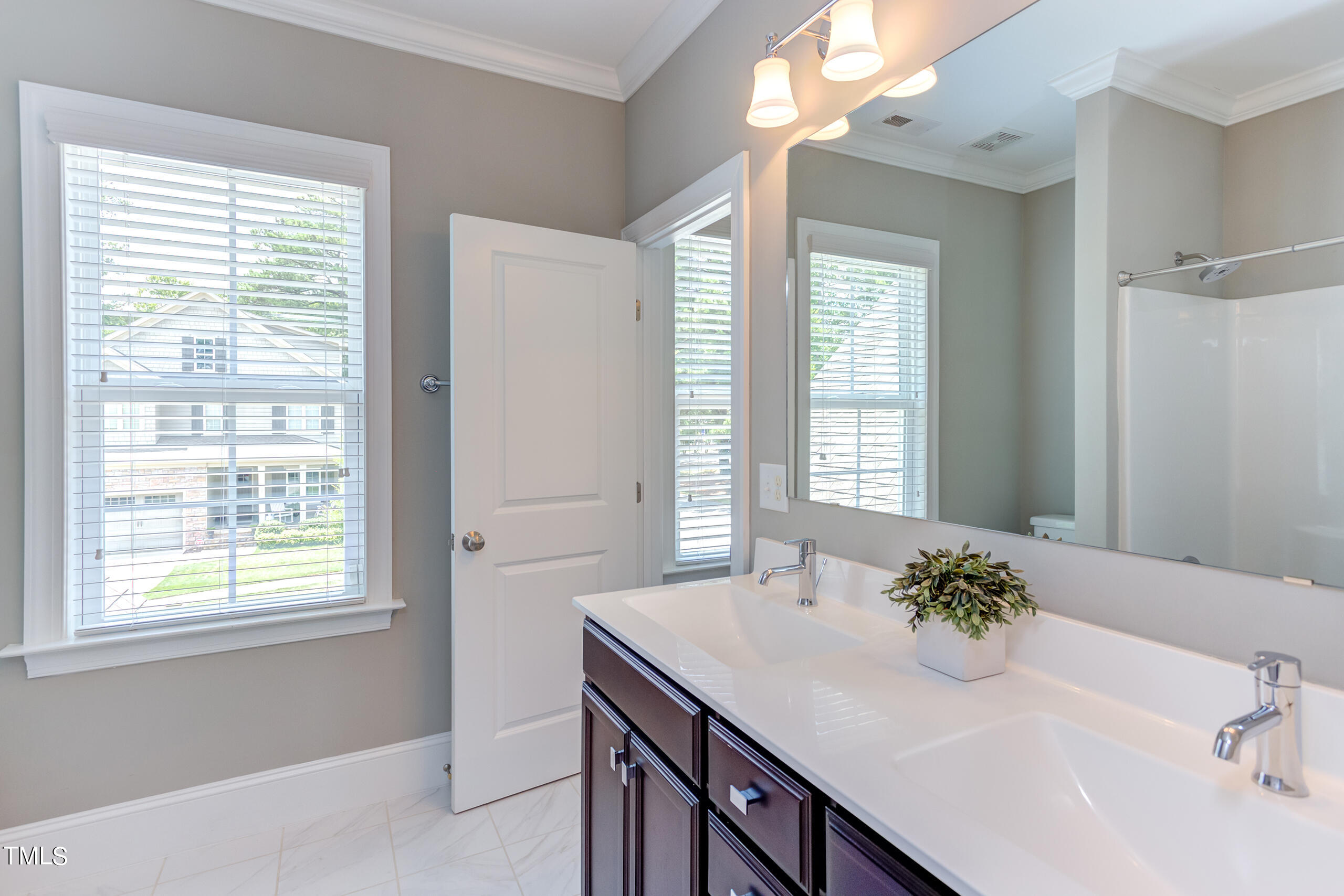 6426 Rosny Road Raleigh, NC 27613 - Photo 32 of 51 a bathroom with a sink and a mirror