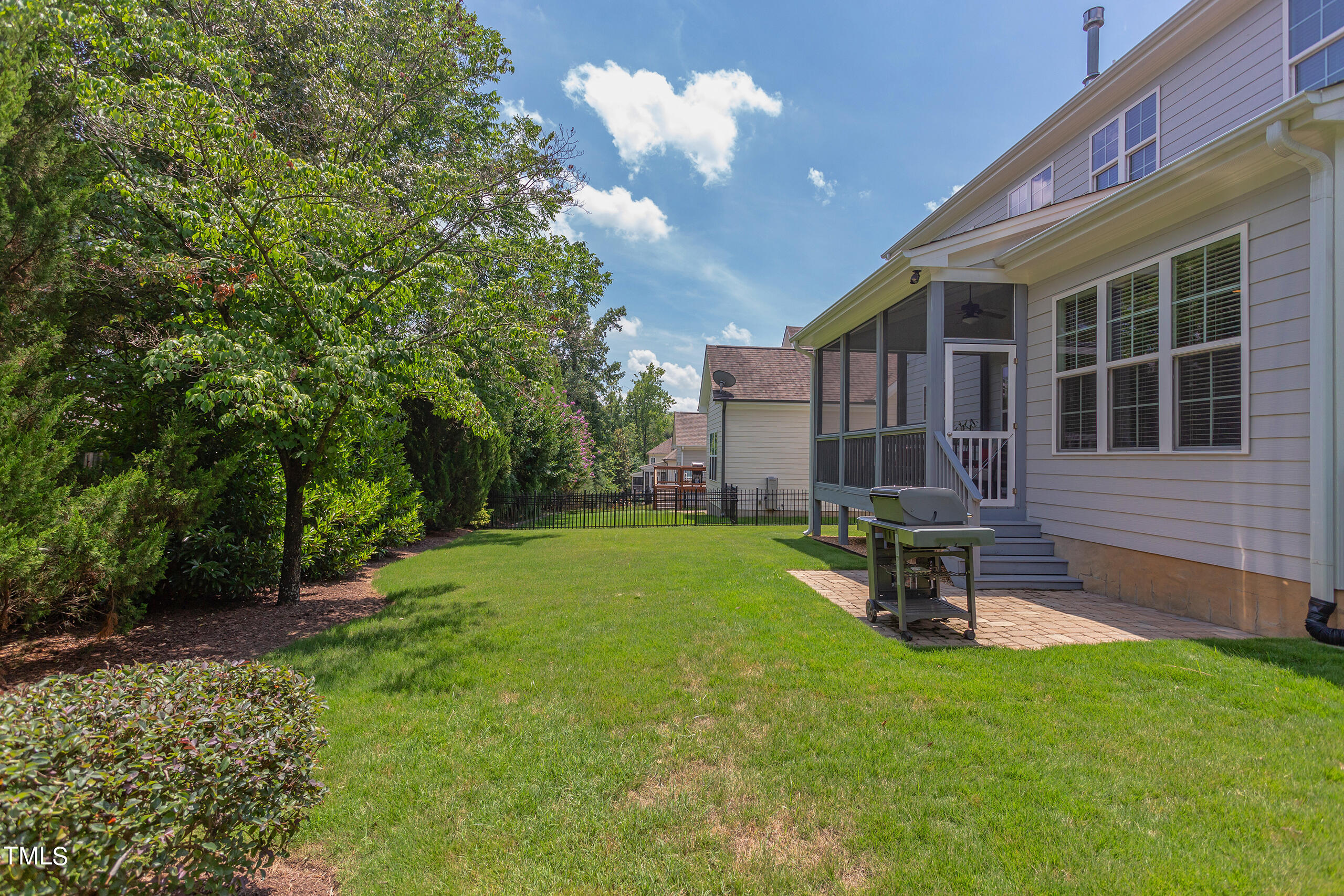 6426 Rosny Road Raleigh, NC 27613 - Photo 47 of 51 a view of a backyard with a sitting area and a garden
