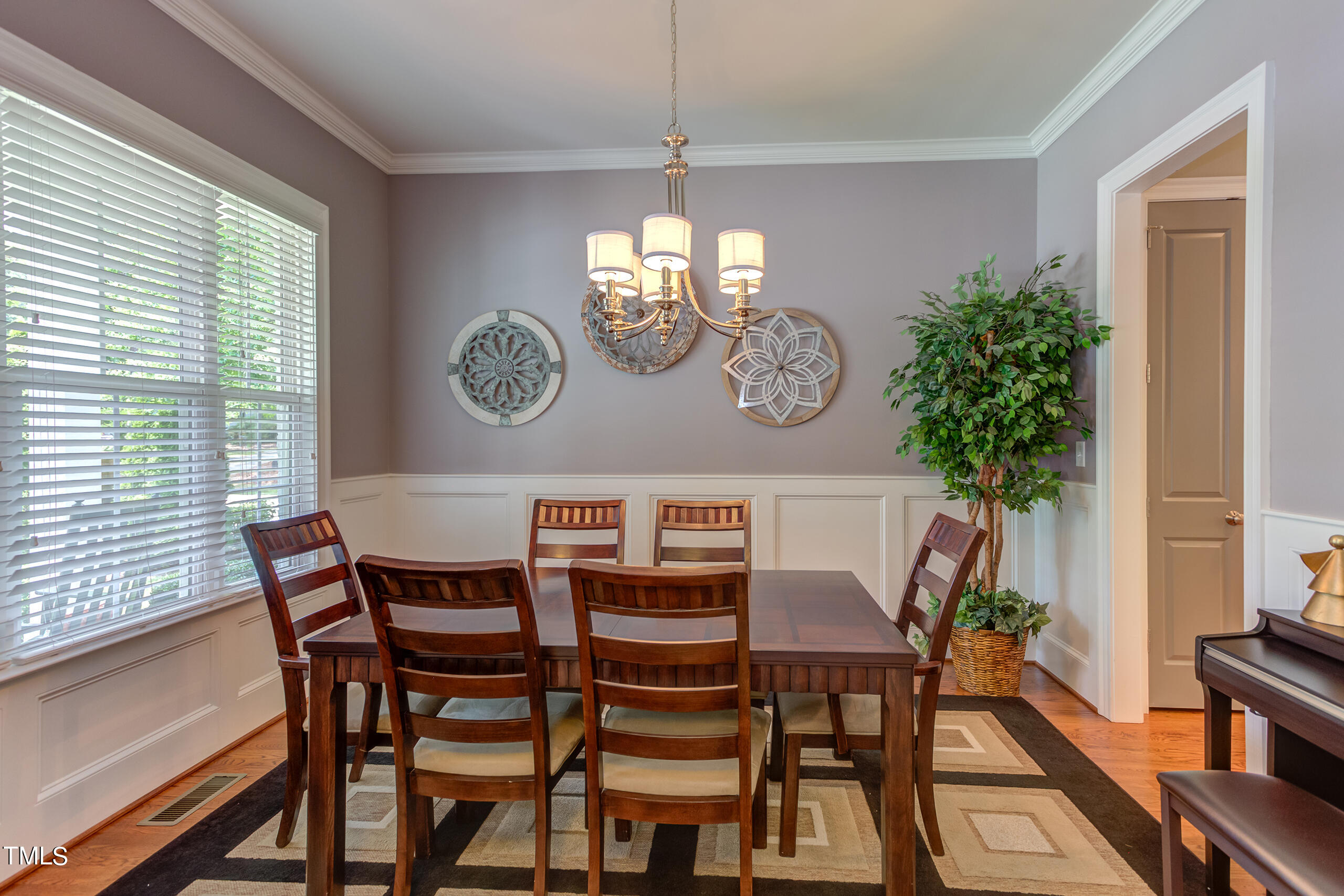 6426 Rosny Road Raleigh, NC 27613 - Photo 10 of 51 a view of a dining room with furniture window and wooden floor