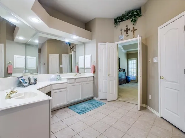 a bathroom with a sink a mirror and a bathtub