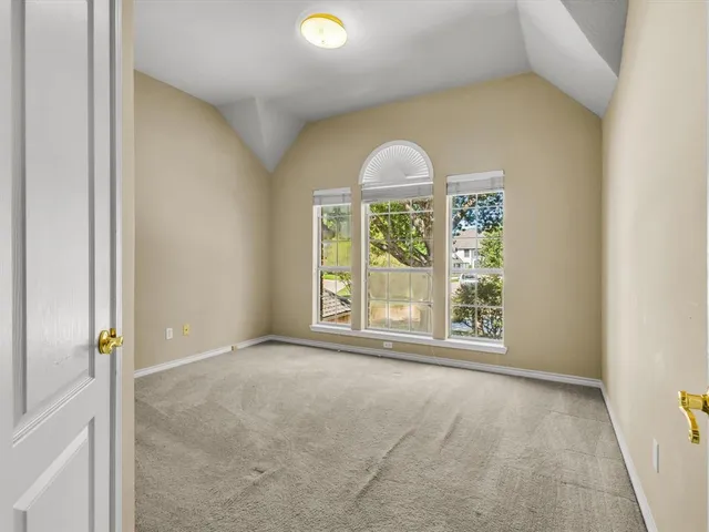 an empty room with windows and outdoor space