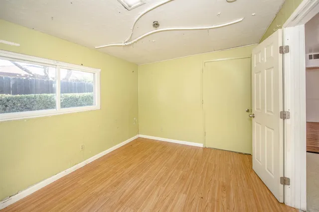 a kitchen with stainless steel appliances kitchen island hardwood floor and window