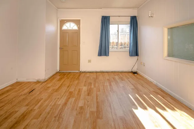 wooden floor with white walls