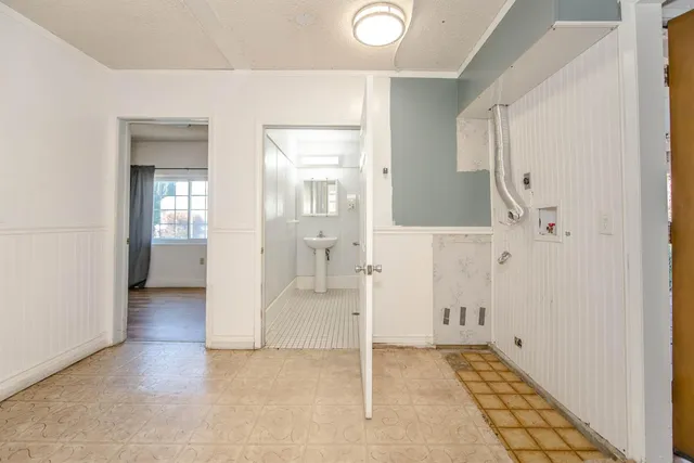 a view of a room with wooden floor and windows