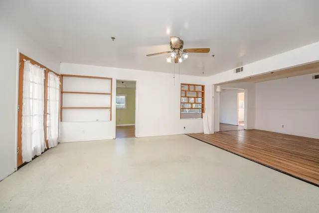 a large white kitchen with cabinets and stainless steel appliances