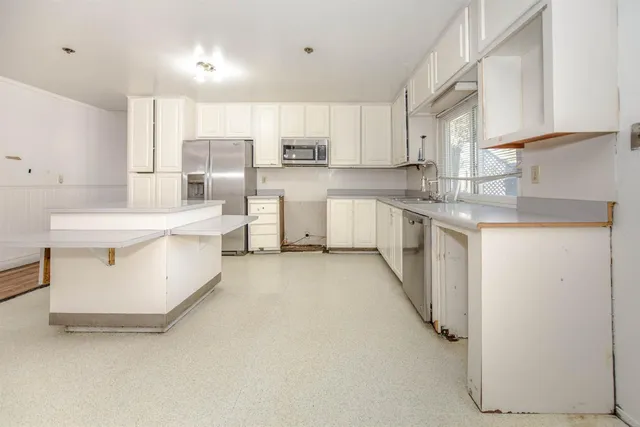 a view of a kitchen with a sink and cabinet