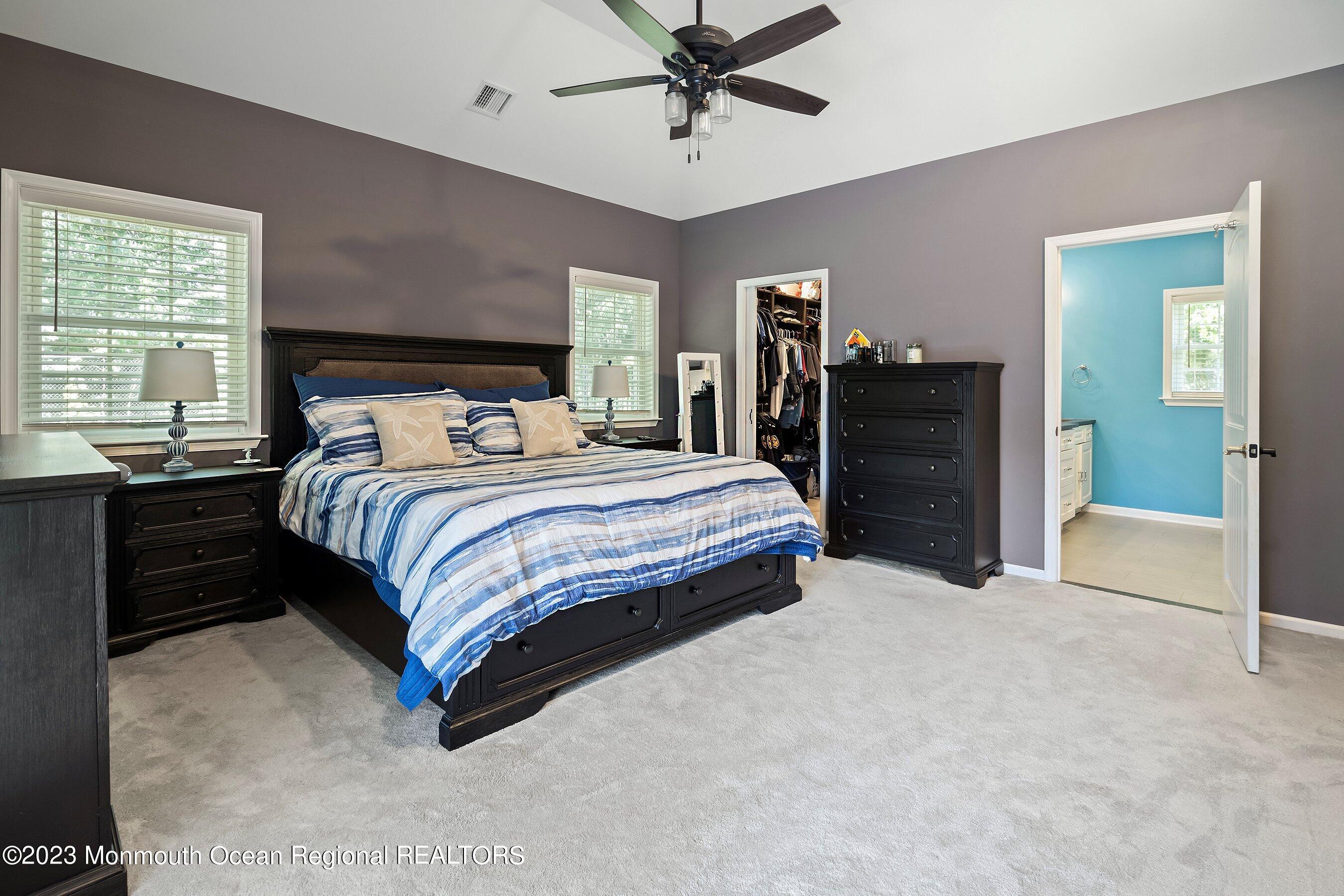 3 Adams Court Howell, NJ 07731 - Photo 11 of 36 a bedroom with a bed and a chandelier