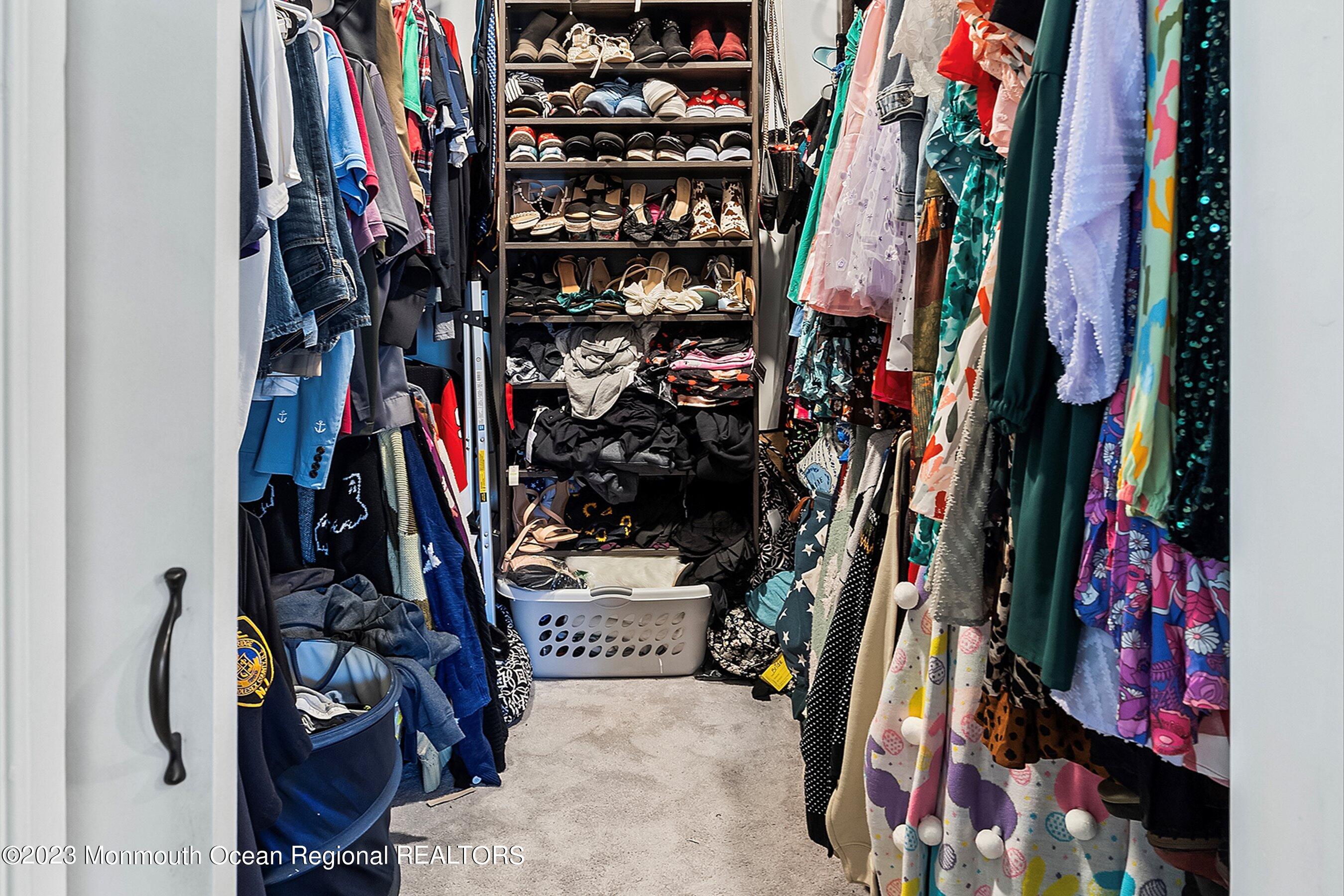 3 Adams Court Howell, NJ 07731 - Photo 13 of 36 a view of walk in closet with clothes and shoes