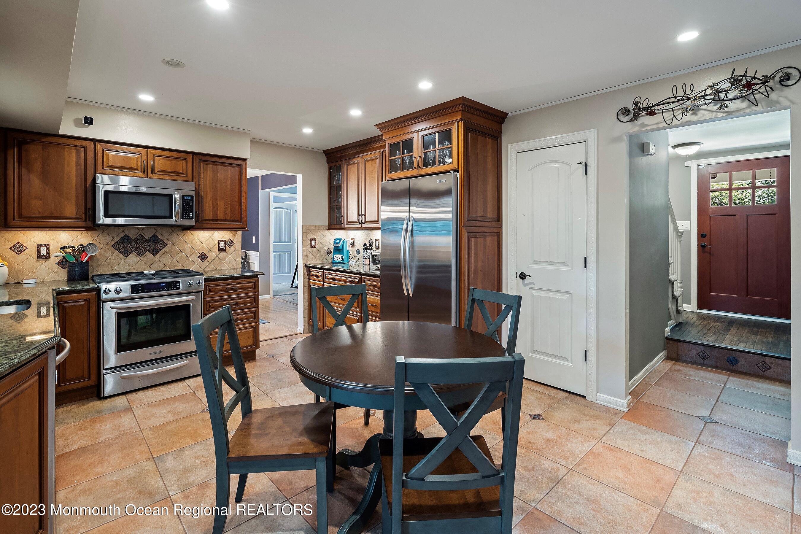 3 Adams Court Howell, NJ 07731 - Photo 20 of 36 a kitchen with stainless steel appliances granite countertop a stove a refrigerator a sink a microwave and a refrigerator