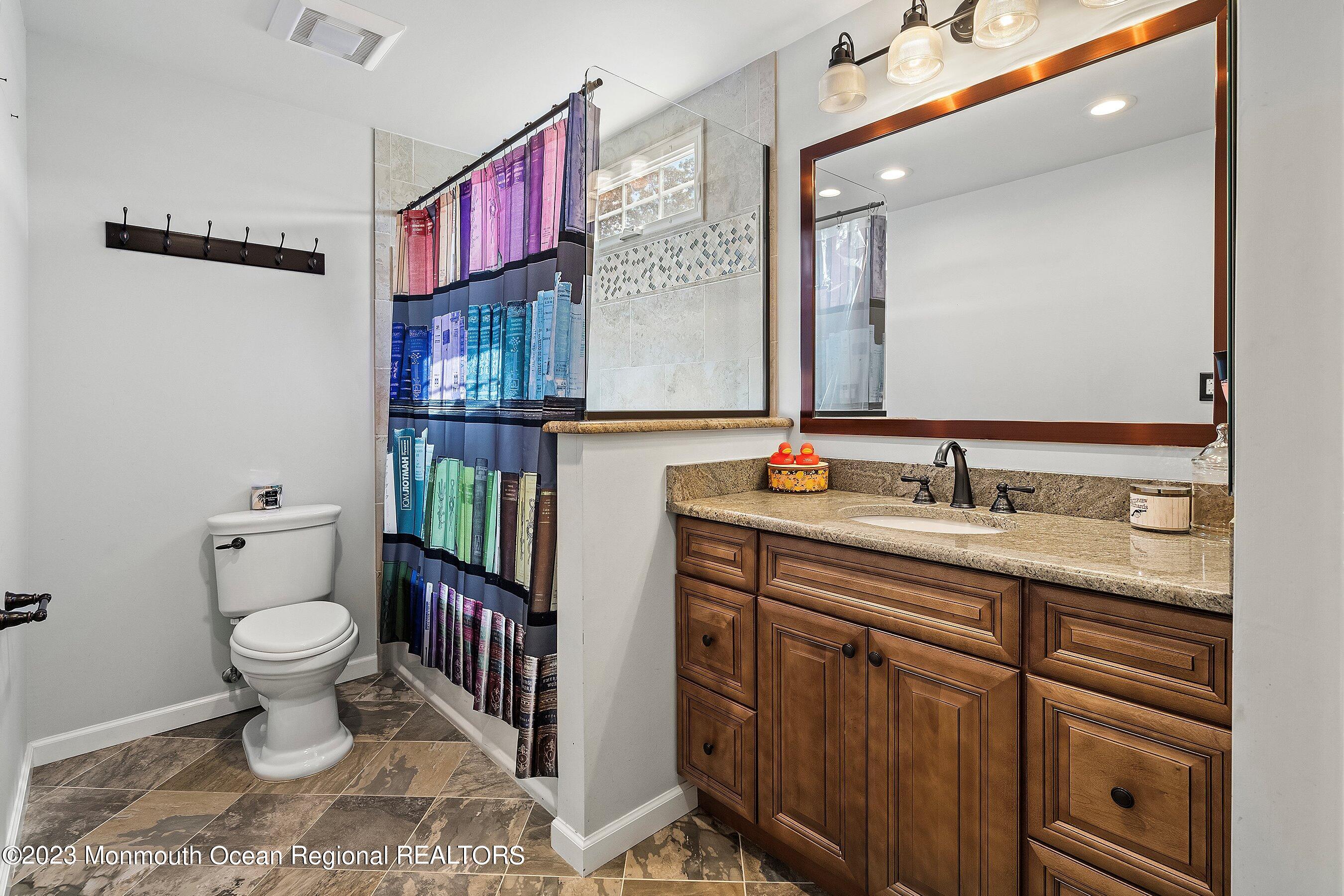 3 Adams Court Howell, NJ 07731 - Photo 26 of 36 a bathroom with a sink a toilet and a mirror
