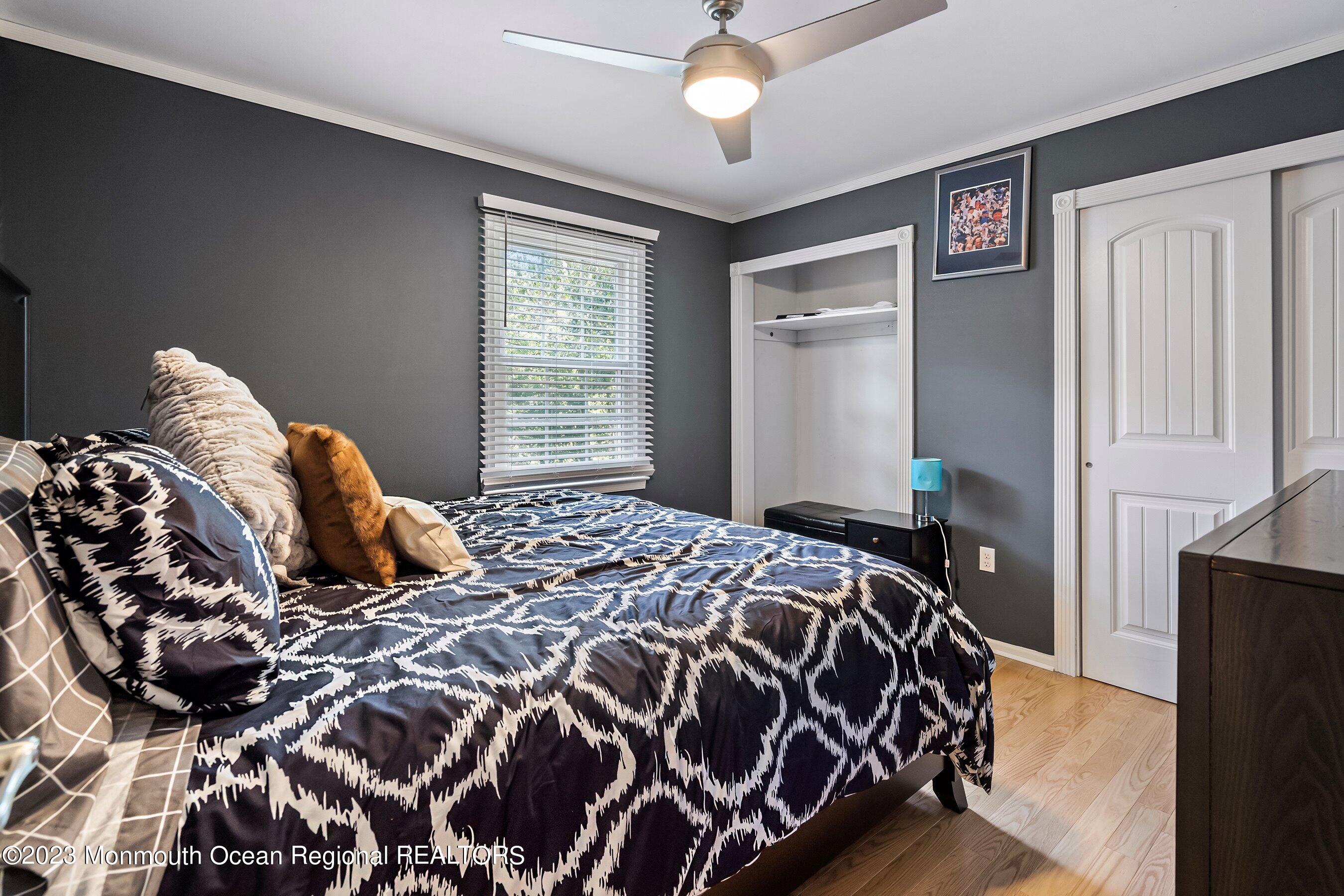 3 Adams Court Howell, NJ 07731 - Photo 27 of 36 a bedroom with a large bed and a chandelier