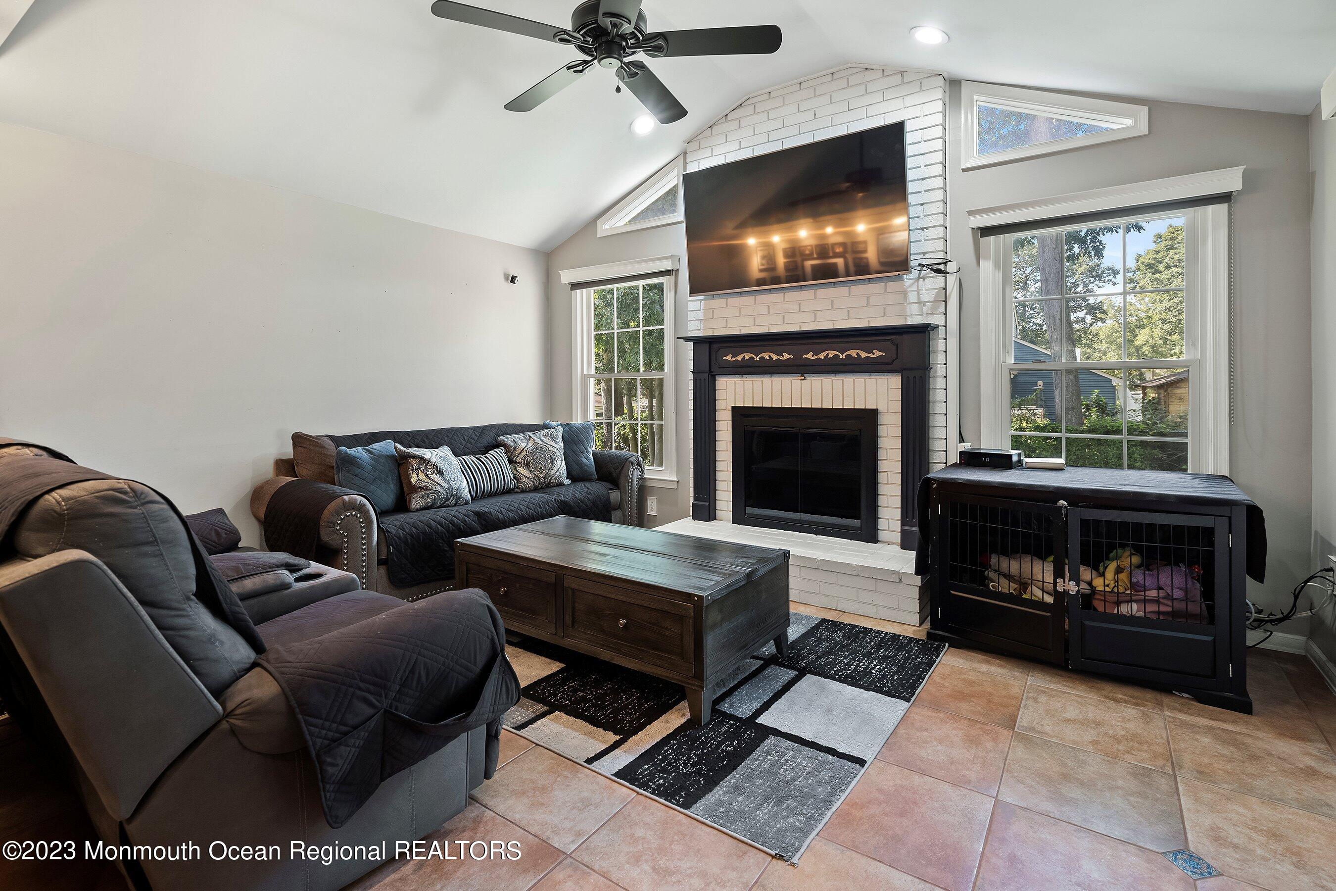 3 Adams Court Howell, NJ 07731 - Photo 28 of 36 a living room with furniture and a fireplace