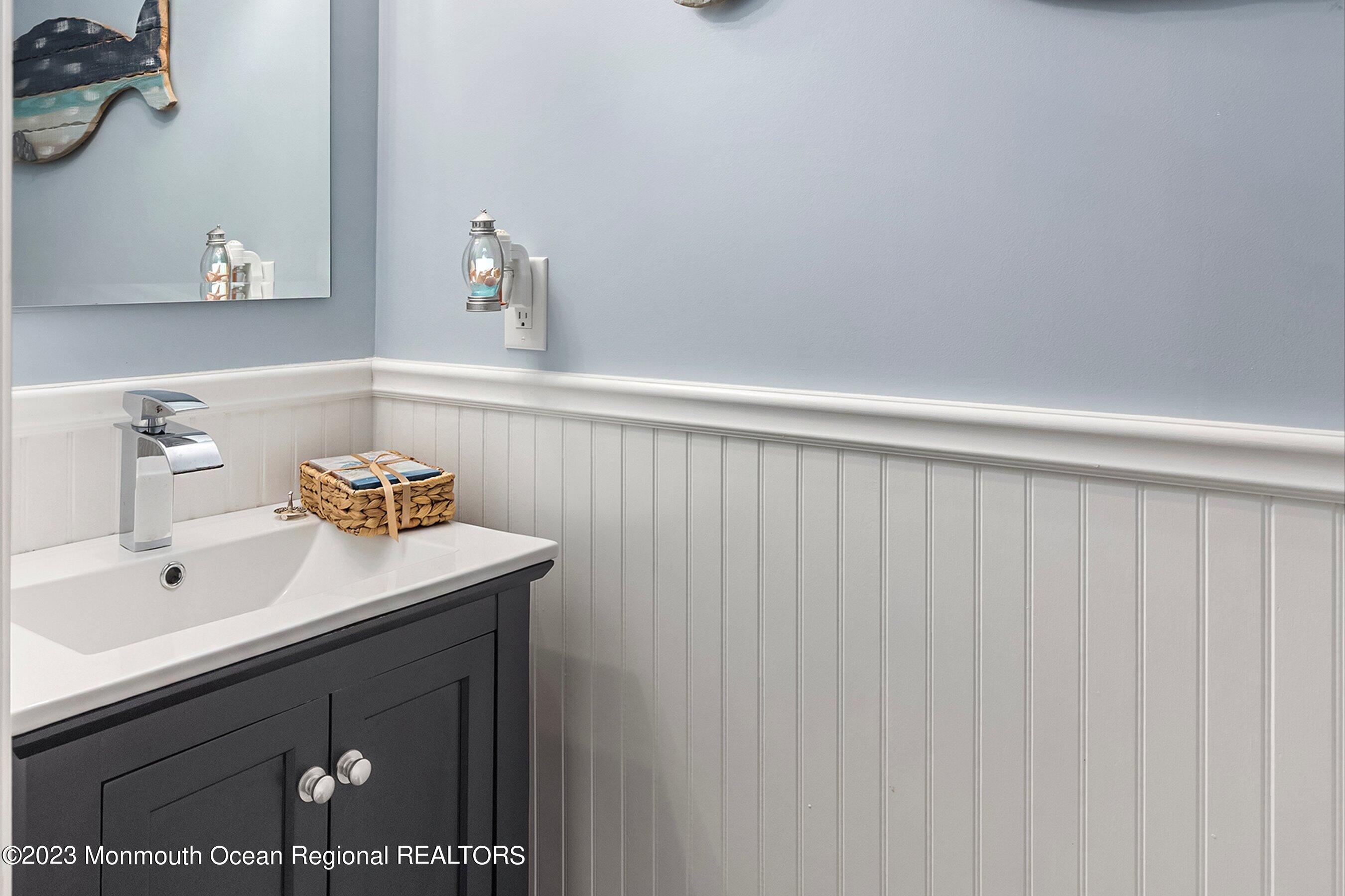 3 Adams Court Howell, NJ 07731 - Photo 33 of 36 a bathroom with a sink and a mirror