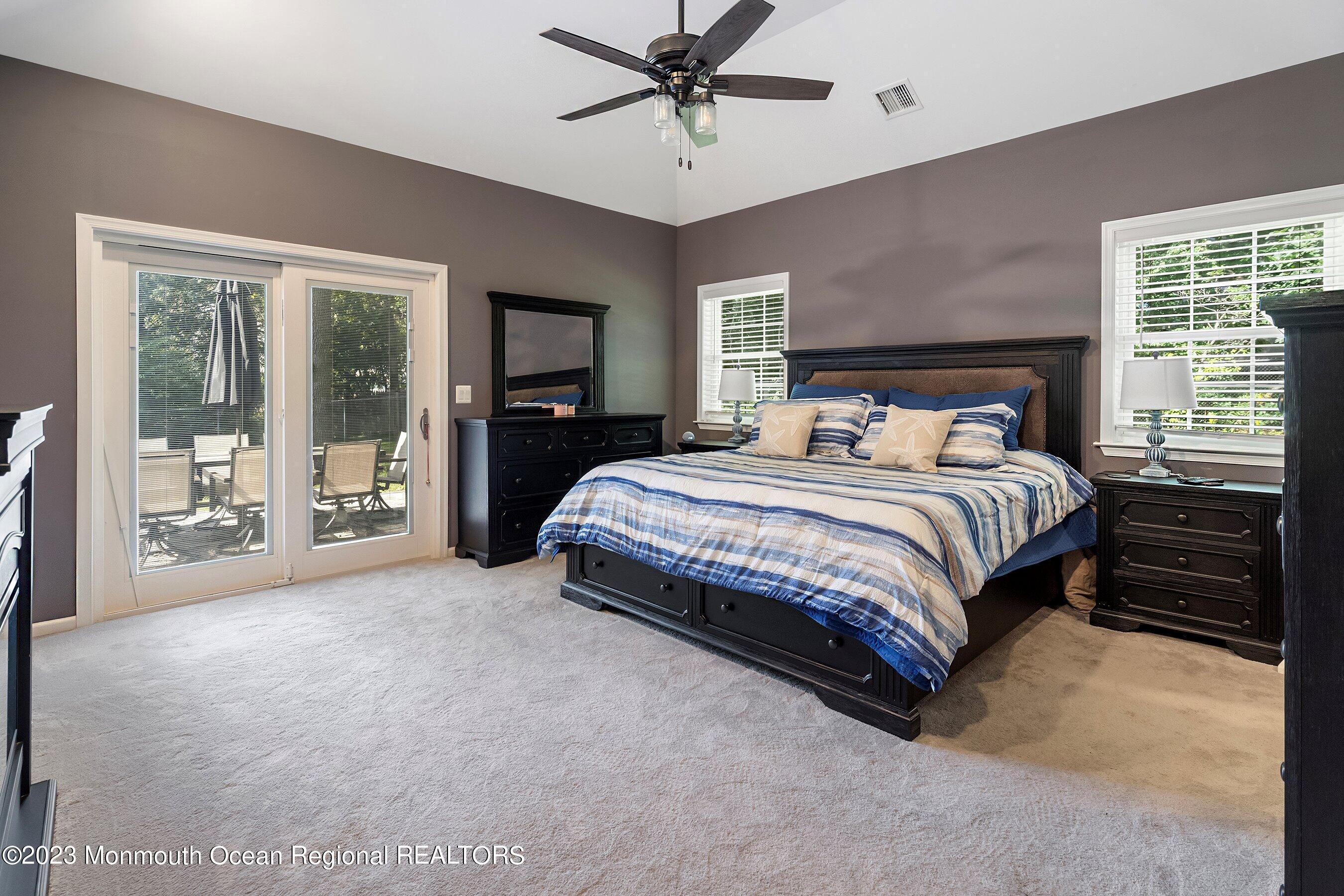 3 Adams Court Howell, NJ 07731 - Photo 9 of 36 a spacious bedroom with a bed and a chandelier