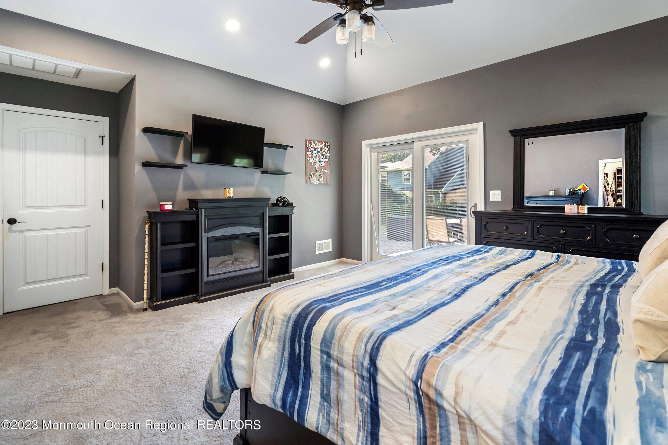 3 Adams Court Howell, NJ 07731 - Photo 10 of 36 a bedroom with a bed and a flat screen television