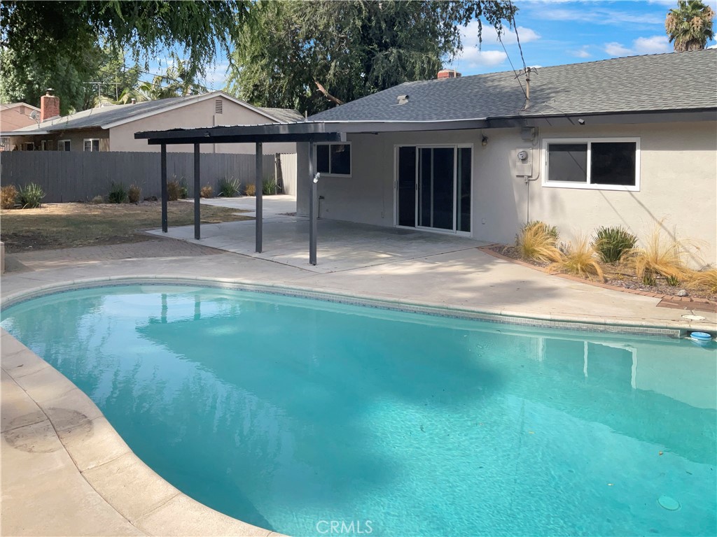 6376 Westview Drive Riverside, CA 92506 - Photo 8 of 23 a backyard of a house with table and chairs under an umbrella