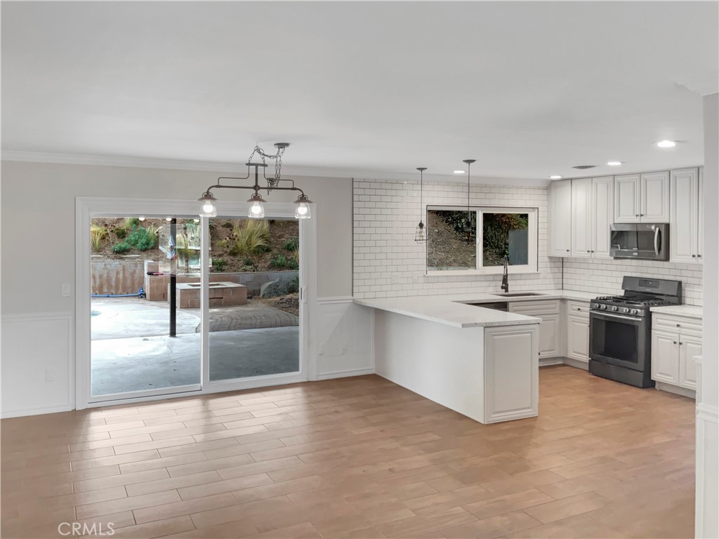 6376 Westview Drive Riverside, CA 92506 - Photo 10 of 23 a kitchen with granite countertop a stove top oven and cabinets