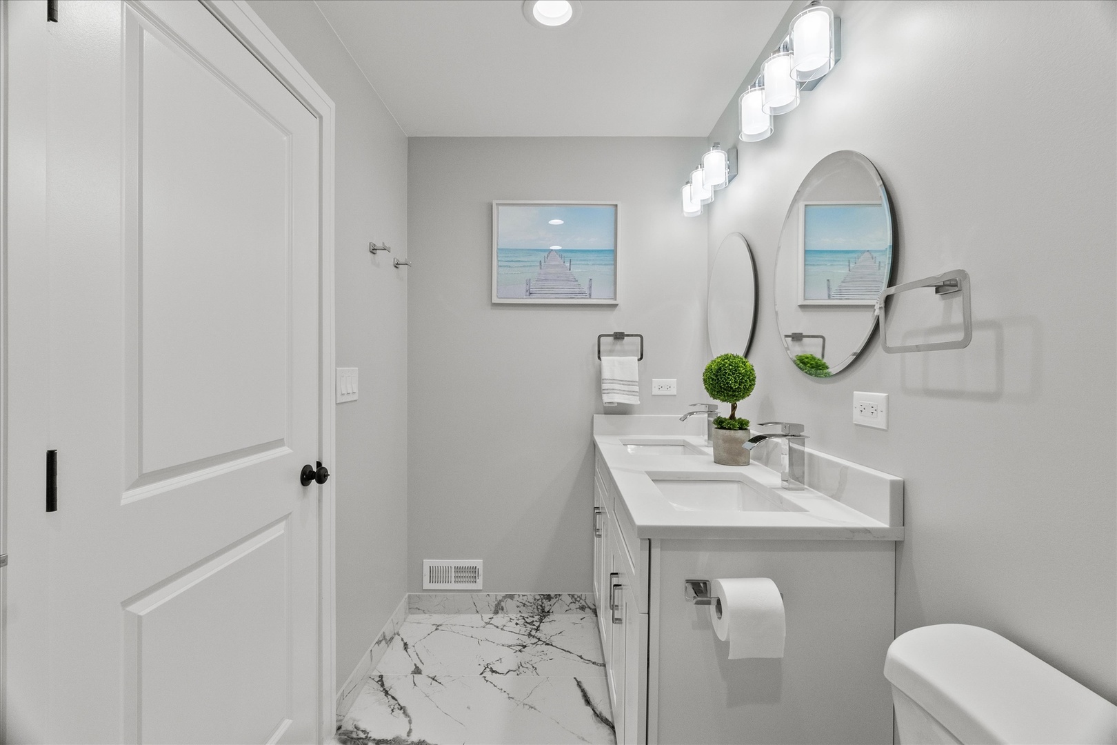 S424 Cadwell Avenue Elmhurst, IL 60126 - Photo 10 of 29 a bathroom with a sink vanity mirror and toilet